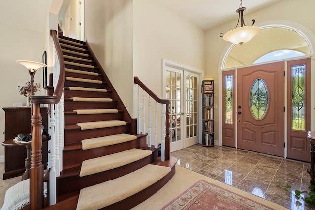 1280 Sylvan Rd, Chelsea, MI 48118 - foyer entrance with stairway, marble finish floor, a towering ceiling, french doors, and baseboards