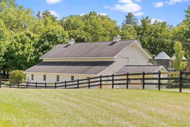 1280 Sylvan Rd, Chelsea, MI 48118 - view of side of property featuring fence, a lawn, a shingled roof, and a barn