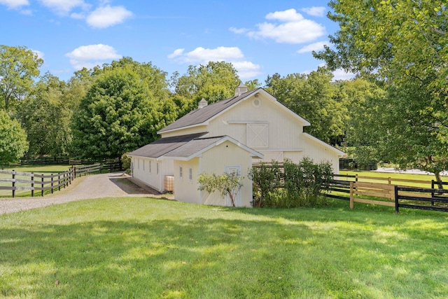 1280 Sylvan Rd, Chelsea, MI 48118 - view of side of home with a chimney, a barn, fence, an outdoor structure, and a lawn