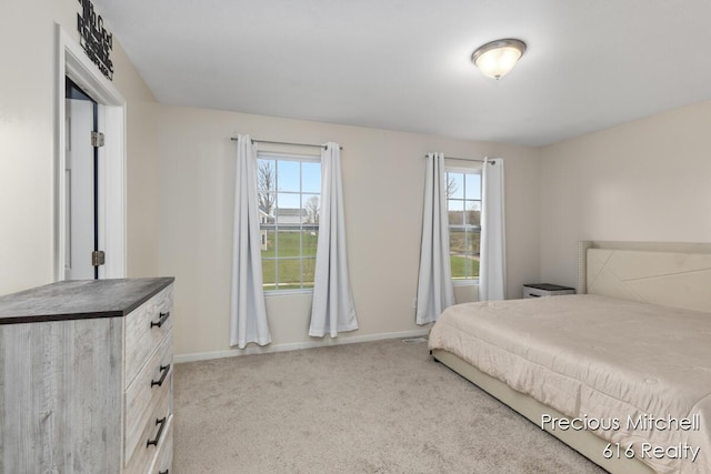 carpeted bedroom with baseboards