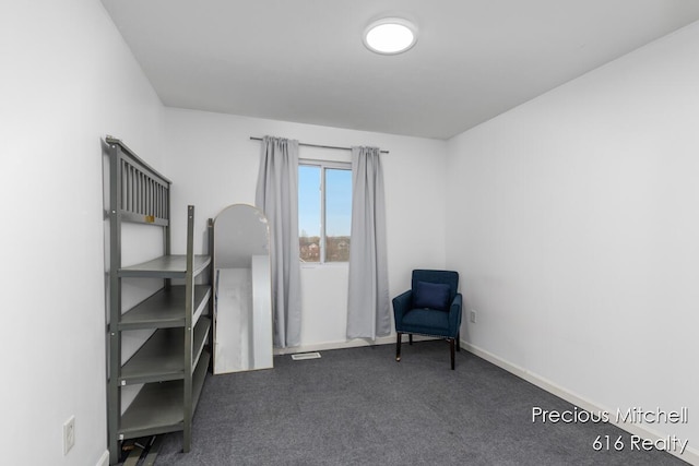 living area with baseboards and carpet flooring