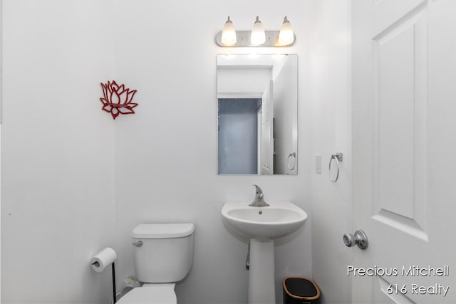 half bathroom featuring toilet