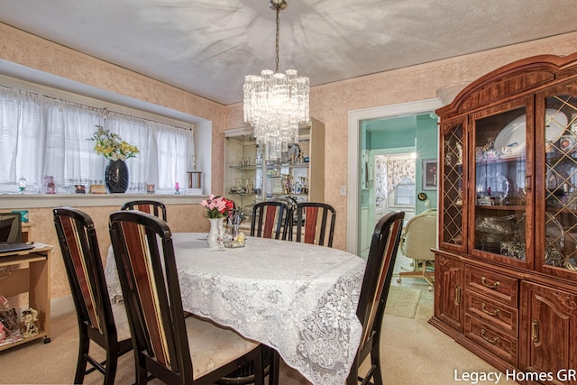 dining area with a chandelier and light carpet
