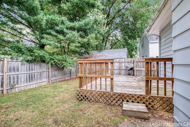 view of yard with a fenced backyard and a wooden deck