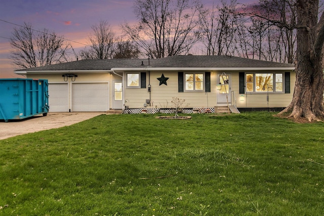 ranch-style house featuring a lawn, driveway, entry steps, and a garage