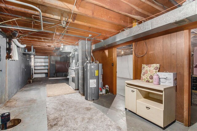 unfinished basement with water heater and heating fuel