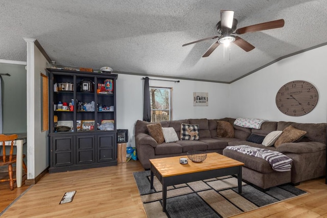 16788 David Ct, Mecosta, MI 49332 - living room featuring lofted ceiling, light wood finished floors, crown molding, a textured ceiling, and ceiling fan