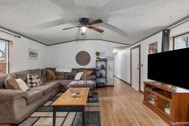 16788 David Ct, Mecosta, MI 49332 - living room featuring a textured ceiling, light wood-type flooring, vaulted ceiling, ceiling fan, and ornamental molding