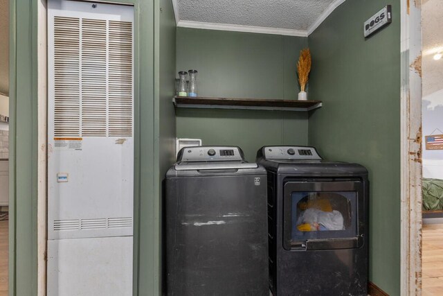 16788 David Ct, Mecosta, MI 49332 - washroom featuring a textured ceiling, ornamental molding, a heating unit, laundry area, and independent washer and dryer