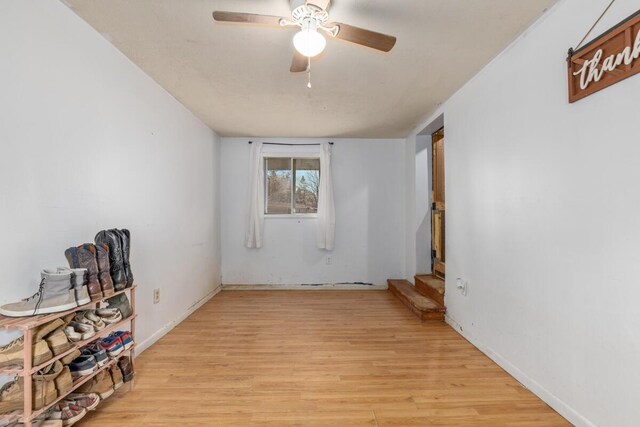 16788 David Ct, Mecosta, MI 49332 - empty room with light wood-style floors and a ceiling fan
