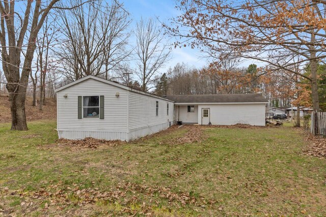 16788 David Ct, Mecosta, MI 49332 - rear view of property with fence and a lawn