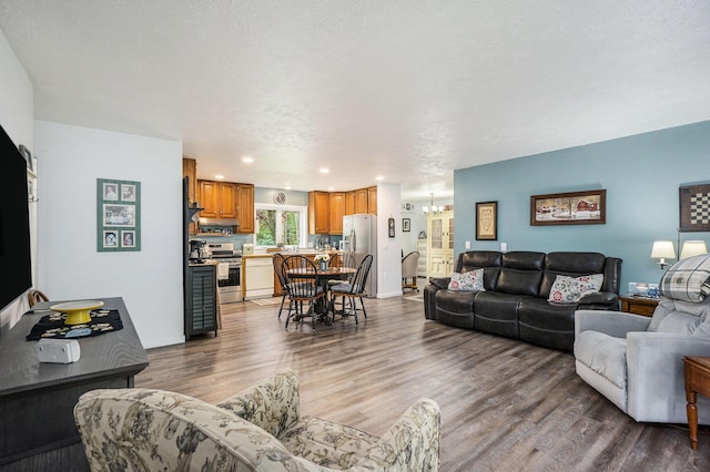 53746 Stevens Ln, Three Rivers, MI 49093 - living area featuring wood finished floors, a chandelier, recessed lighting, and baseboards