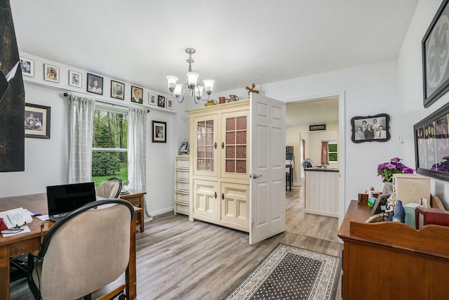53746 Stevens Ln, Three Rivers, MI 49093 - home office featuring a chandelier, healthy amount of natural light, wood finished floors, and baseboards
