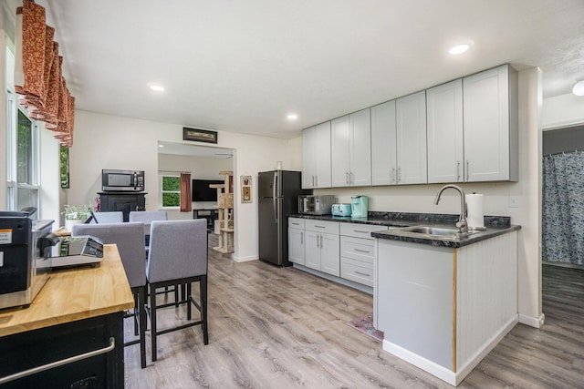 53746 Stevens Ln, Three Rivers, MI 49093 - kitchen featuring a sink, stainless steel appliances, light wood finished floors, recessed lighting, and baseboards