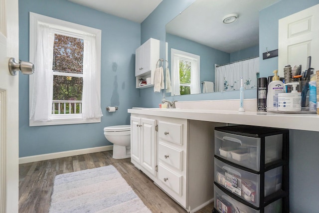 53746 Stevens Ln, Three Rivers, MI 49093 - full bath with toilet, wood finished floors, vanity, baseboards, and a shower with shower curtain