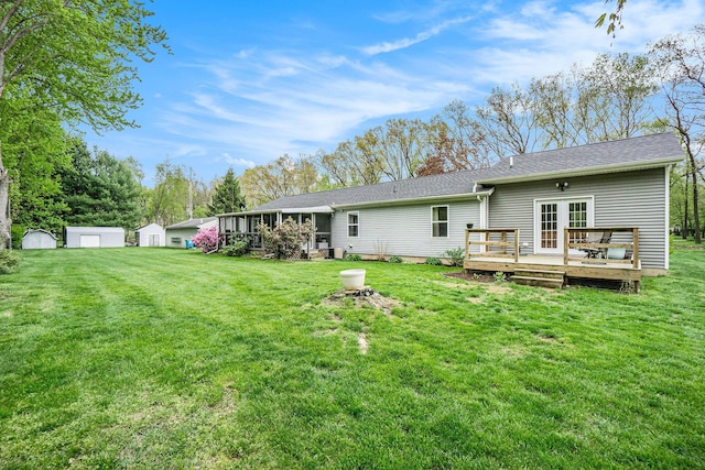 53746 Stevens Ln, Three Rivers, MI 49093 - back of house featuring a wooden deck, french doors, a lawn, and a sunroom