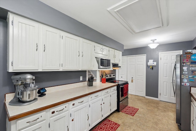 kitchen featuring white cabinetry, appliances with stainless steel finishes, and light countertops