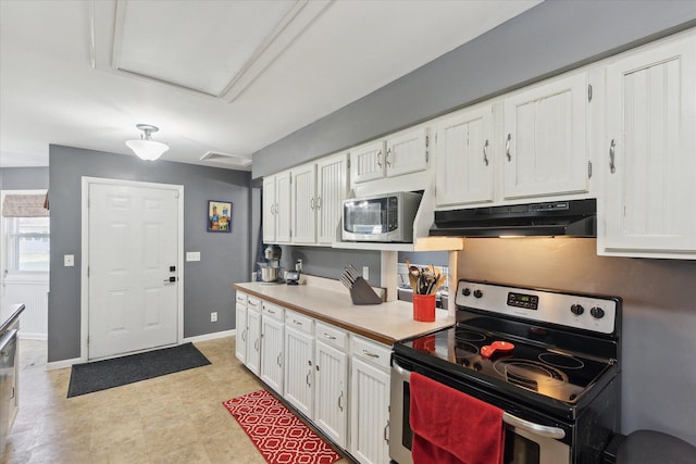kitchen featuring appliances with stainless steel finishes, white cabinetry, light countertops, and under cabinet range hood