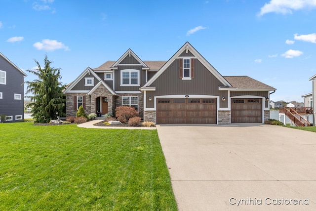 11325 Wake Dr, Allendale, MI 49401 - craftsman house with board and batten siding, concrete driveway, a front yard, and stone siding