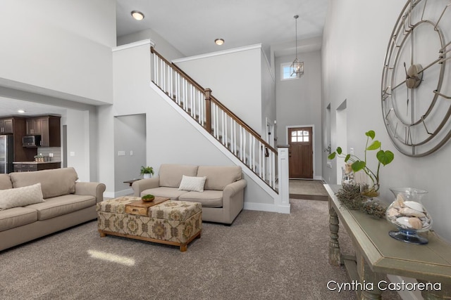 11325 Wake Dr, Allendale, MI 49401 - carpeted living room with baseboards, recessed lighting, a high ceiling, and stairway