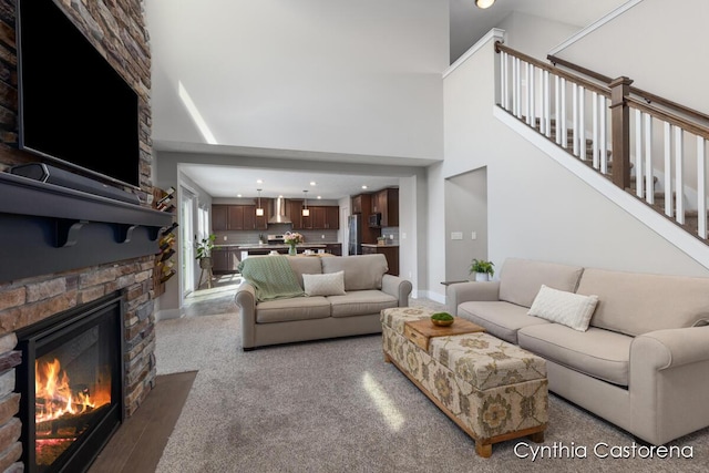 11325 Wake Dr, Allendale, MI 49401 - carpeted living room with recessed lighting, a stone fireplace, and a towering ceiling
