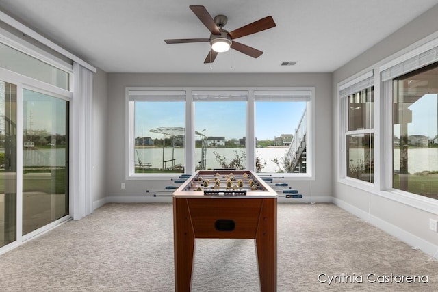 11325 Wake Dr, Allendale, MI 49401 - recreation room with carpet floors, visible vents, baseboards, ceiling fan, and a water view