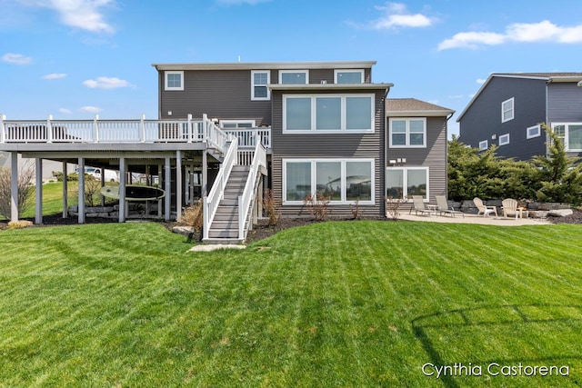 11325 Wake Dr, Allendale, MI 49401 - rear view of property with stairs, a patio area, a wooden deck, and a lawn