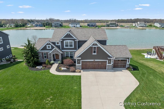 11325 Wake Dr, Allendale, MI 49401 - craftsman-style house with a water view, concrete driveway, a front yard, and stone siding