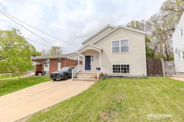 view of front of property with a front lawn and fence