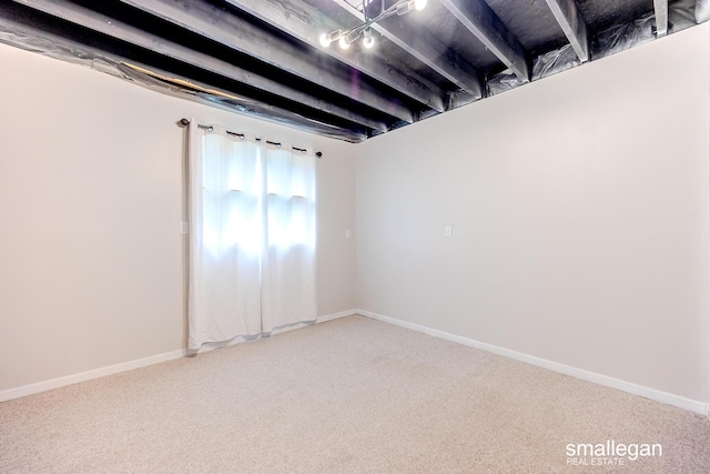 carpeted empty room with baseboards