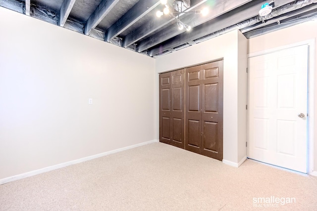 finished below grade area featuring baseboards and carpet