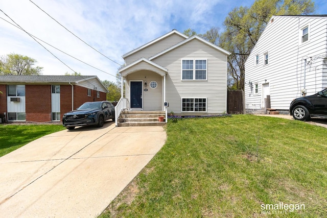 tri-level home with a front lawn