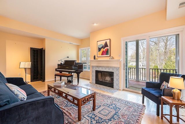 285 Mulholland Ave, Ann Arbor, MI 48103 - living area featuring visible vents, a tiled fireplace, and light wood-style flooring
