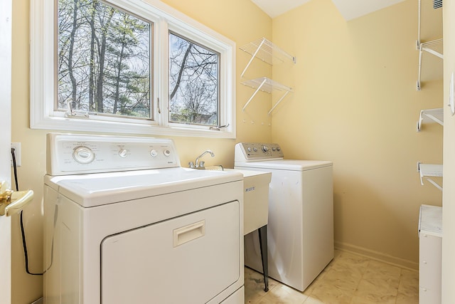 285 Mulholland Ave, Ann Arbor, MI 48103 - laundry area with washer and clothes dryer, baseboards, a wealth of natural light, and laundry area