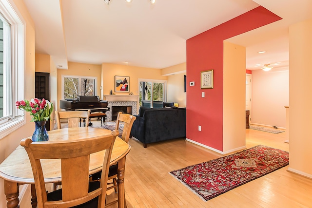 285 Mulholland Ave, Ann Arbor, MI 48103 - dining area featuring baseboards, light wood-type flooring, and a tile fireplace