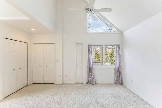285 Mulholland Ave, Ann Arbor, MI 48103 - unfurnished bedroom with baseboards, high vaulted ceiling, two closets, and carpet flooring