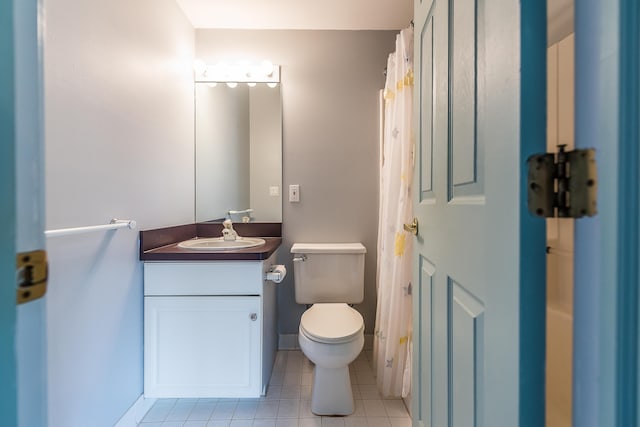 285 Mulholland Ave, Ann Arbor, MI 48103 - bathroom with tile patterned floors, baseboards, toilet, and vanity