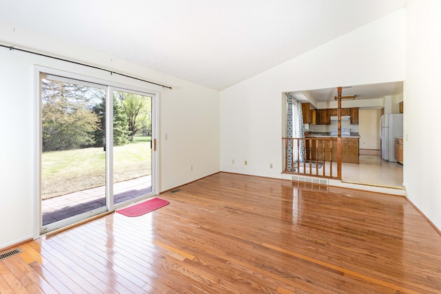 3126 Fairhaven Ct, Ann Arbor, MI 48105 - unfurnished living room featuring visible vents, light wood-type flooring, and lofted ceiling