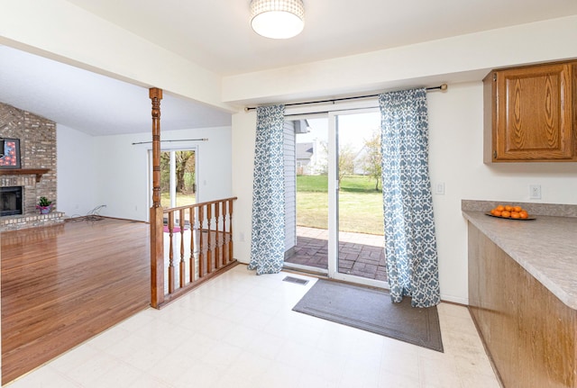 3126 Fairhaven Ct, Ann Arbor, MI 48105 - entryway featuring a brick fireplace, visible vents, plenty of natural light, and vaulted ceiling