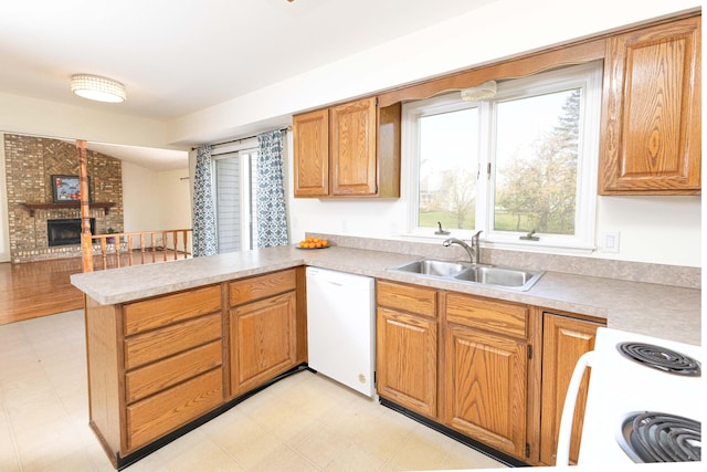3126 Fairhaven Ct, Ann Arbor, MI 48105 - kitchen with a peninsula, light countertops, electric range oven, a sink, and dishwasher