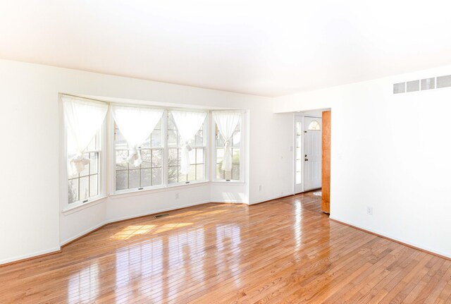 3126 Fairhaven Ct, Ann Arbor, MI 48105 - empty room with baseboards, light wood finished floors, and visible vents