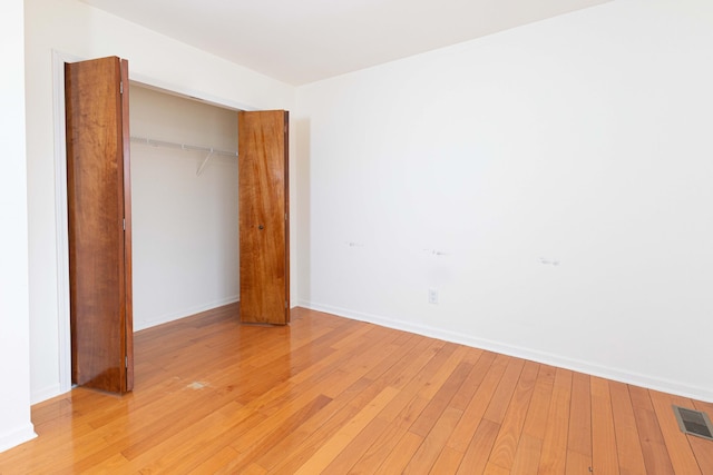 3126 Fairhaven Ct, Ann Arbor, MI 48105 - unfurnished bedroom with baseboards, a closet, light wood-style flooring, and visible vents