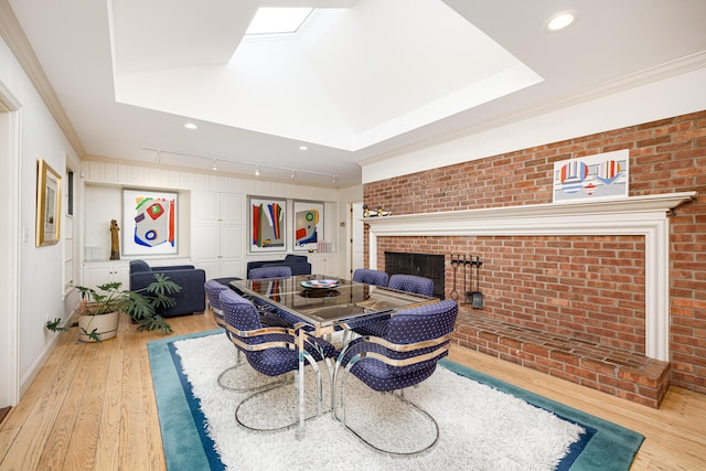 1060 Chestnut St, Ann Arbor, MI 48104 - dining room with a brick fireplace, ornamental molding, wood finished floors, and brick wall