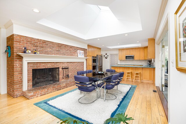 1060 Chestnut St, Ann Arbor, MI 48104 - dining area featuring ornamental molding, recessed lighting, light wood-style flooring, and a fireplace