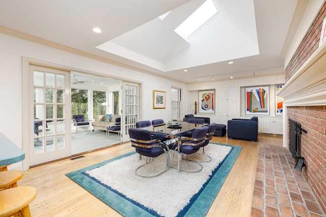 1060 Chestnut St, Ann Arbor, MI 48104 - dining area with crown molding, light wood-type flooring, recessed lighting, and a fireplace