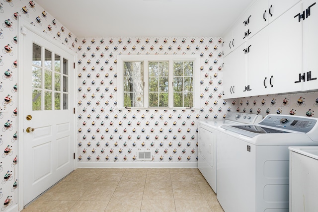 1060 Chestnut St, Ann Arbor, MI 48104 - laundry room featuring a healthy amount of sunlight, wallpapered walls, cabinet space, washing machine and clothes dryer, and baseboards