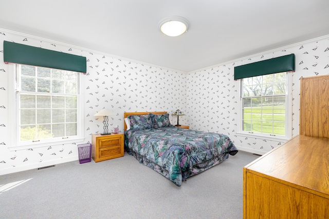 1060 Chestnut St, Ann Arbor, MI 48104 - bedroom with wallpapered walls, carpet flooring, baseboards, visible vents, and crown molding