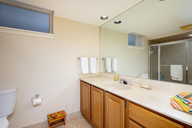 1060 Chestnut St, Ann Arbor, MI 48104 - bathroom with an enclosed shower, toilet, recessed lighting, and vanity