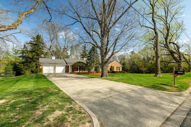 1060 Chestnut St, Ann Arbor, MI 48104 - view of front of home with driveway, a chimney, a front yard, brick siding, and a garage