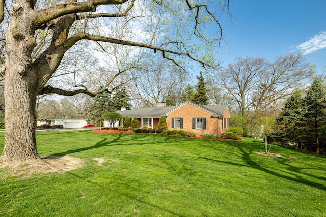 1060 Chestnut St, Ann Arbor, MI 48104 - view of front of house with a chimney, brick siding, and a front yard